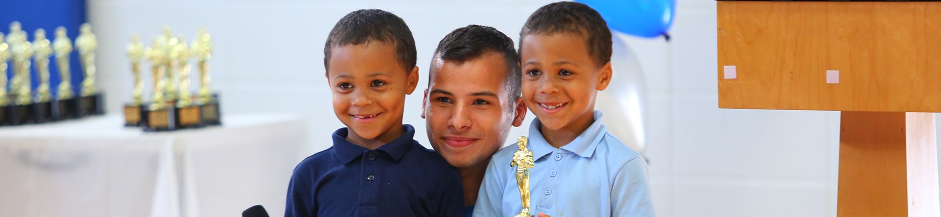 Intern taking a picture with two BGCG kids
